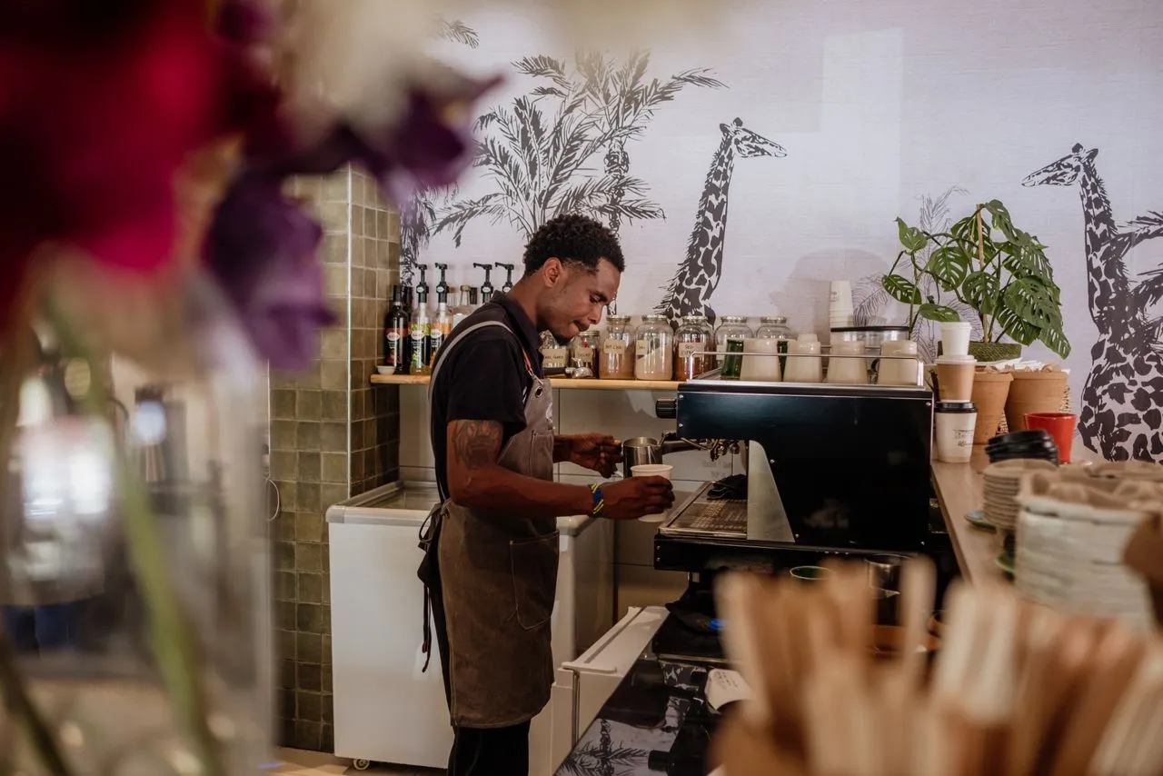 Professional barista crafting specialty coffee at Alfresco Bakery